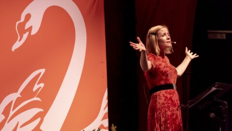 Lucy Worsley on stage with the Stratford Literary Festival logo in the background.